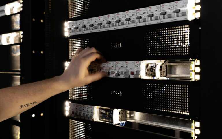 Hand stellt Komponenten im Serverschrank ein – On-Premise-Betrieb im eigenen Unternehmen